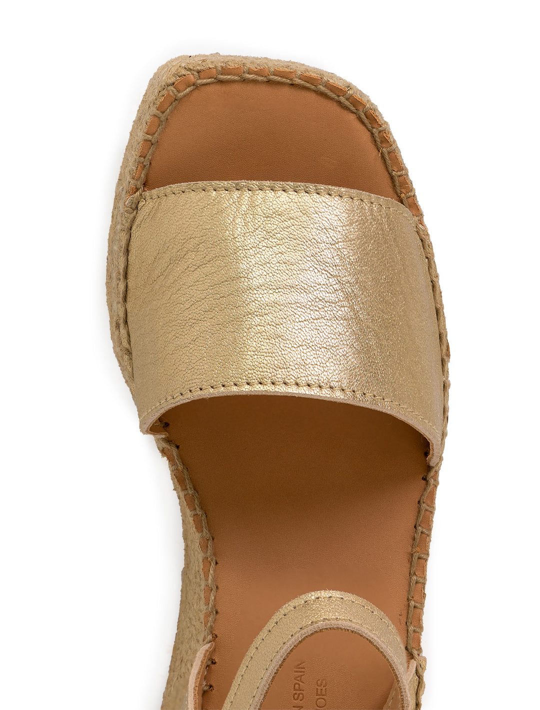 Close-up view of Naguisa's rall espadrille wedge in metallic gold.