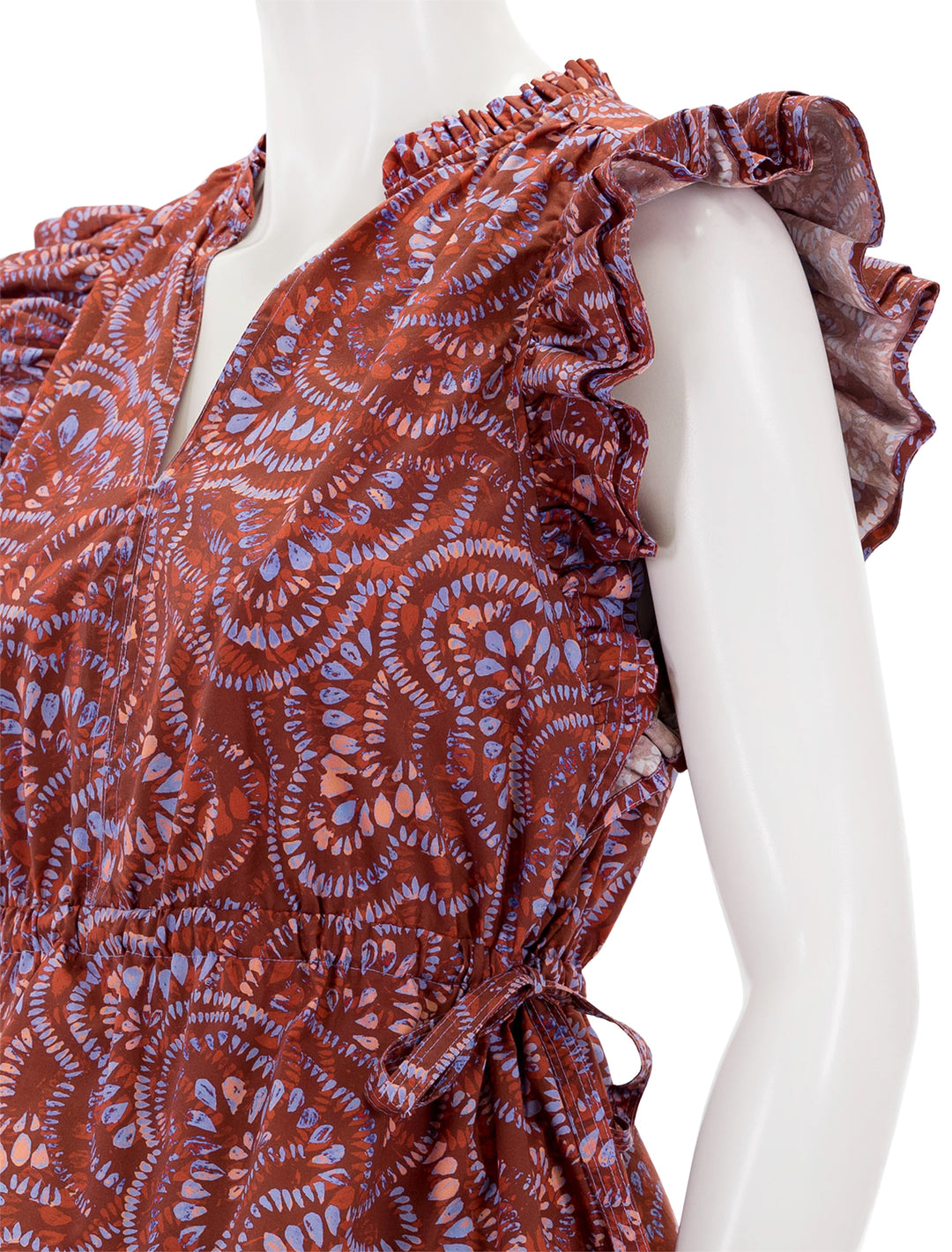 Close-up view of Marie Oliver's olive top in cranberry burst.