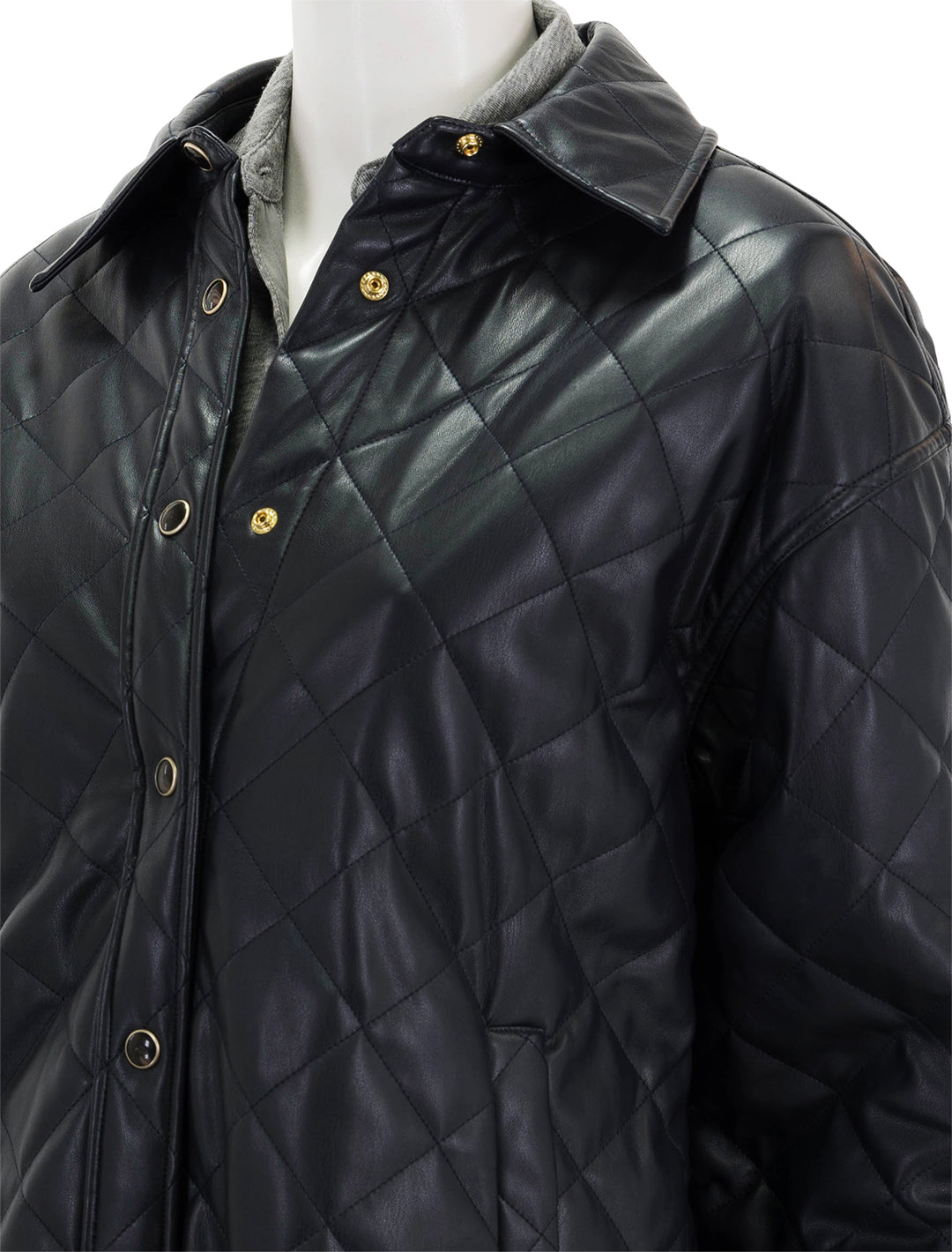 Close-up view of Scotch & Soda's faux leather quilted shirt jacket in night.