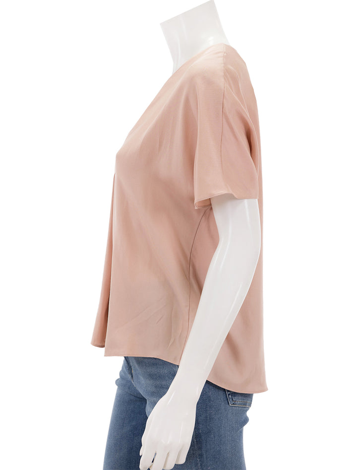 Side view of Vince's short sleeve v neck blouse in tuberose.