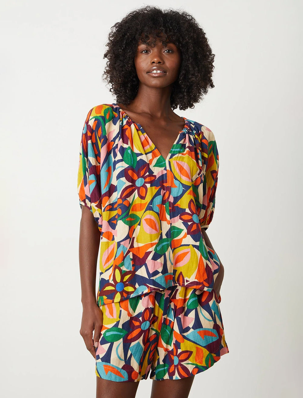 Model wearing Velvet's robin blouse in multi print.