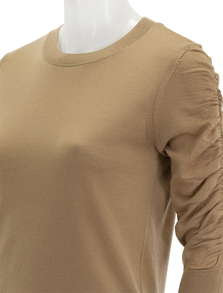 Close-up view of Veronica Beard's kase pullover in camel.