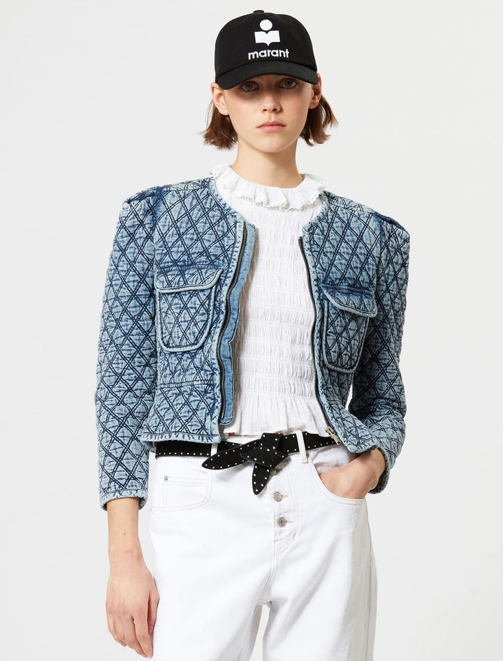 Model wearing  Isabel Marant Etoile's deliona jacket in light blue denim quilting.