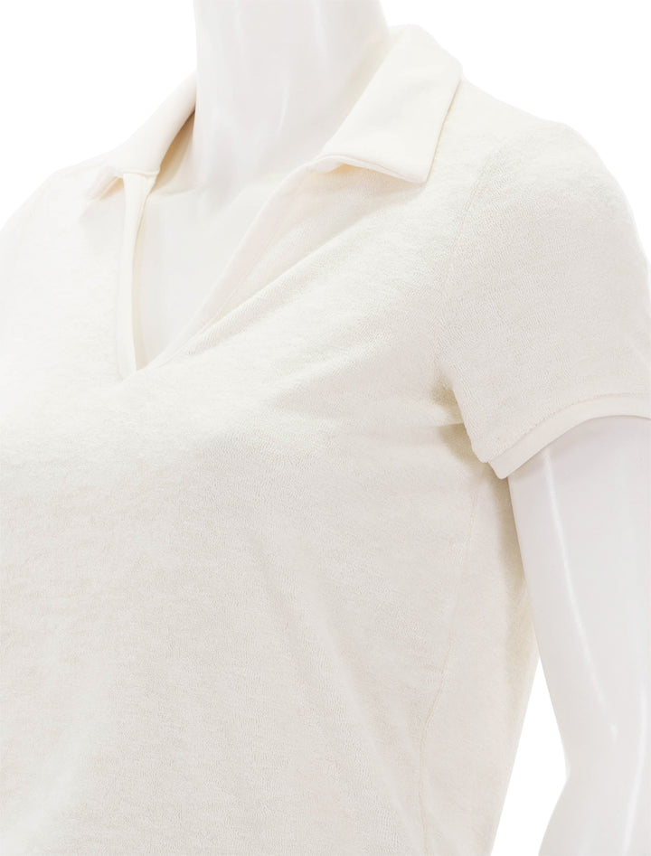 Close-up view of Marine Layer's vintage polo in antique white.