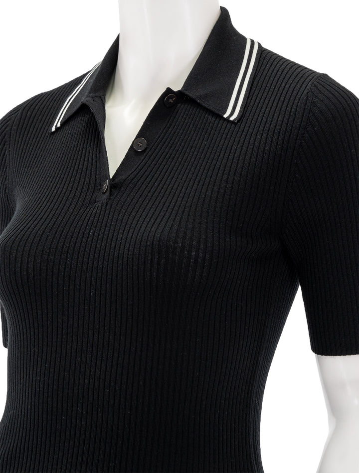 Close-up view of Theory's tipped rib polo in black and vachetta.