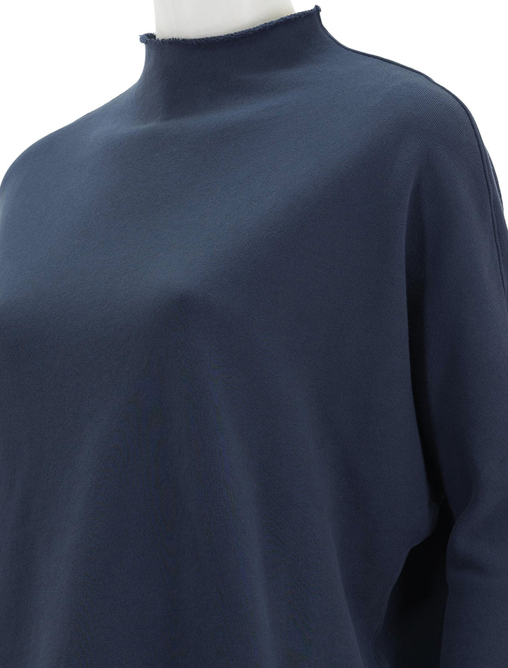Close-up view of Frank & Eileen's effie long sleeve funnel neck capelet in atlantic.