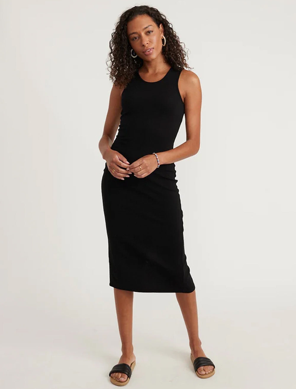 Model wearing Marine Layer's lexi rib daytime midi dress in black.