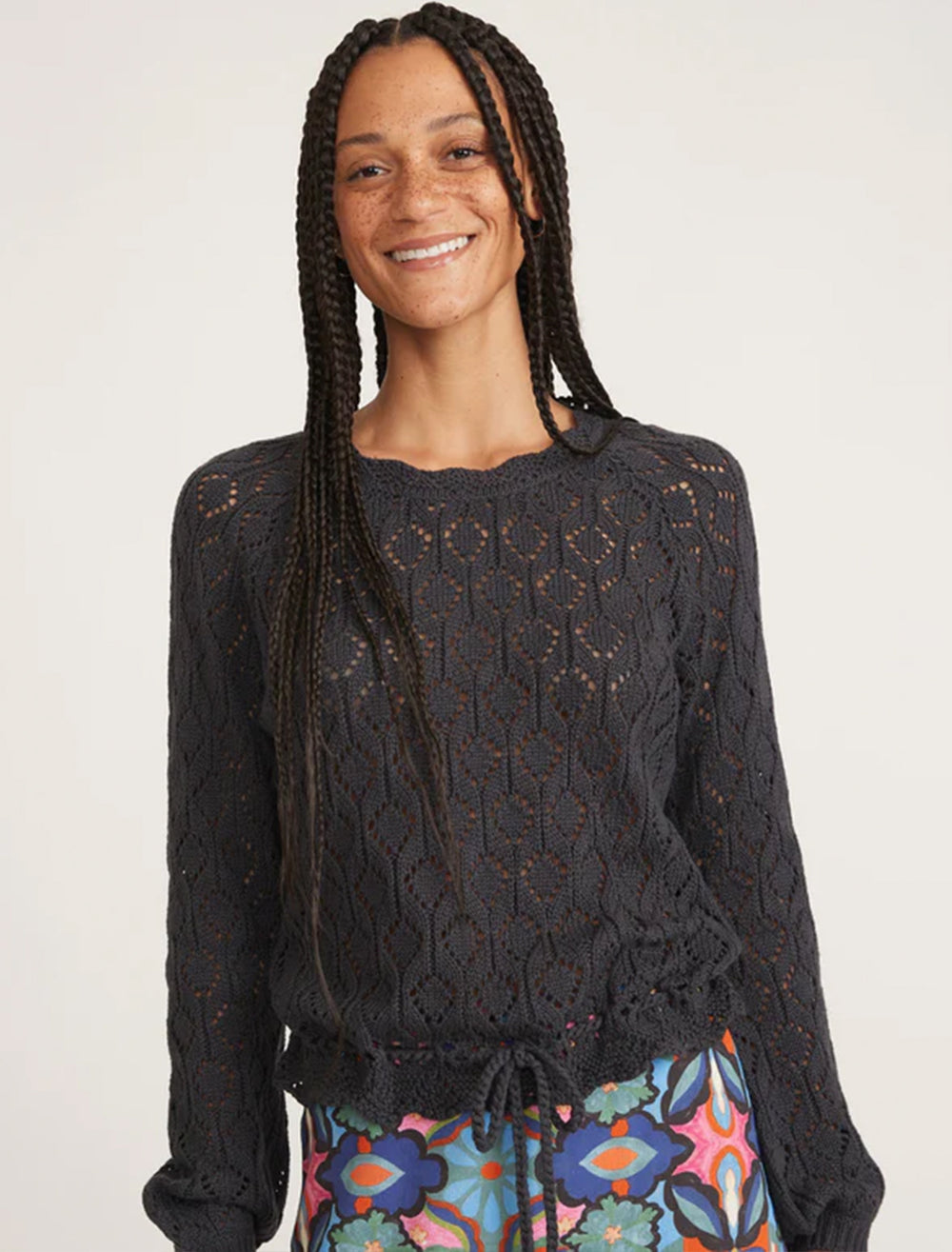 Model wearing Marine Layer's manazanita crochet fringe sweater in black.