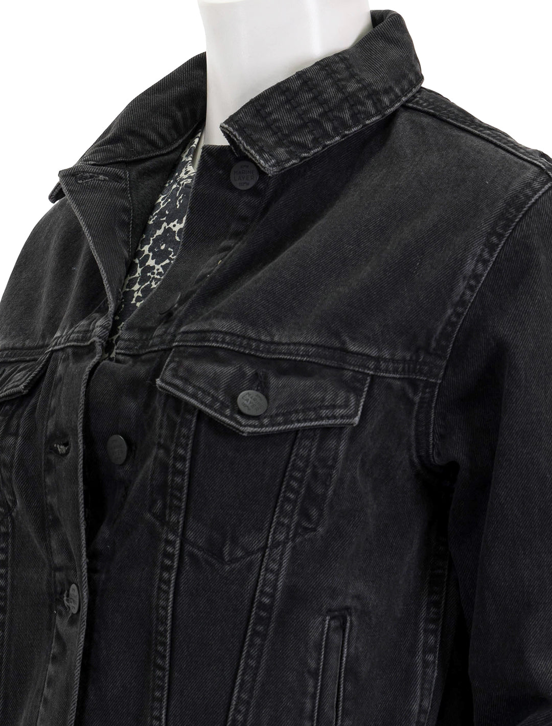 Close-up view of Marine Layer's oversized denim jacket in washed black.