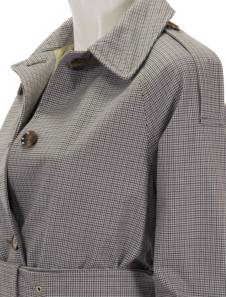 Close-up view of Barbour's marie check showerproof mini check trench.