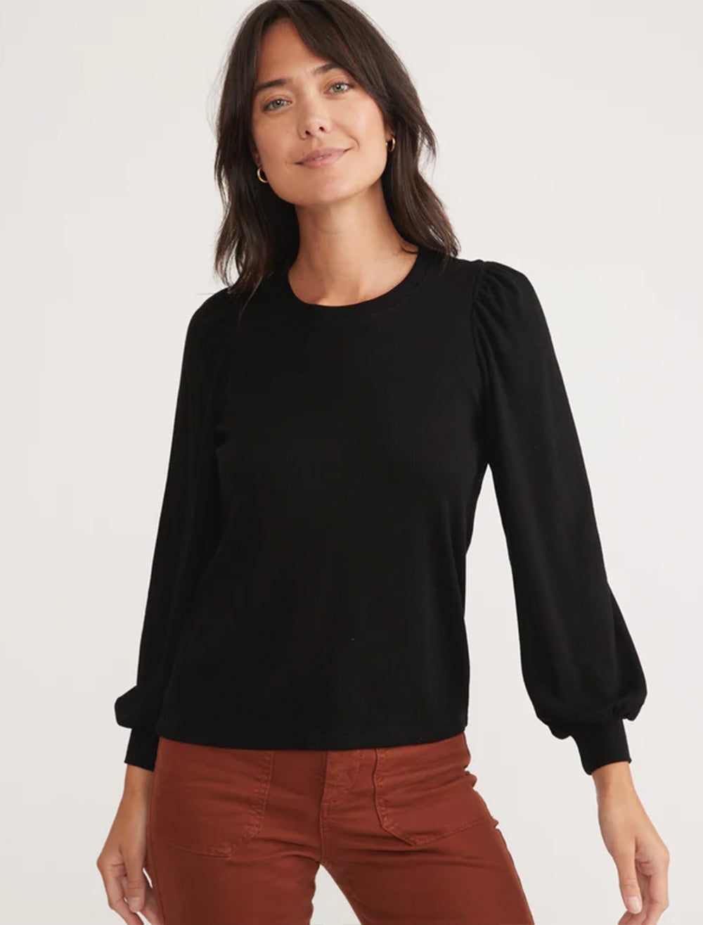 Model wearing marine layer's lexi puff sleeve top in black.