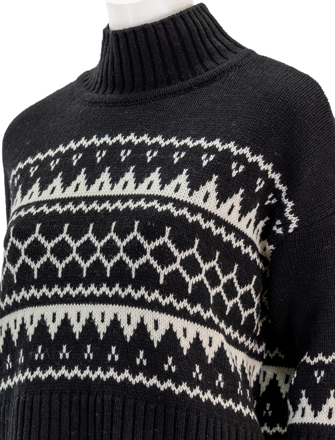 Close-up view of Barbour's pine knit turtleneck in black.