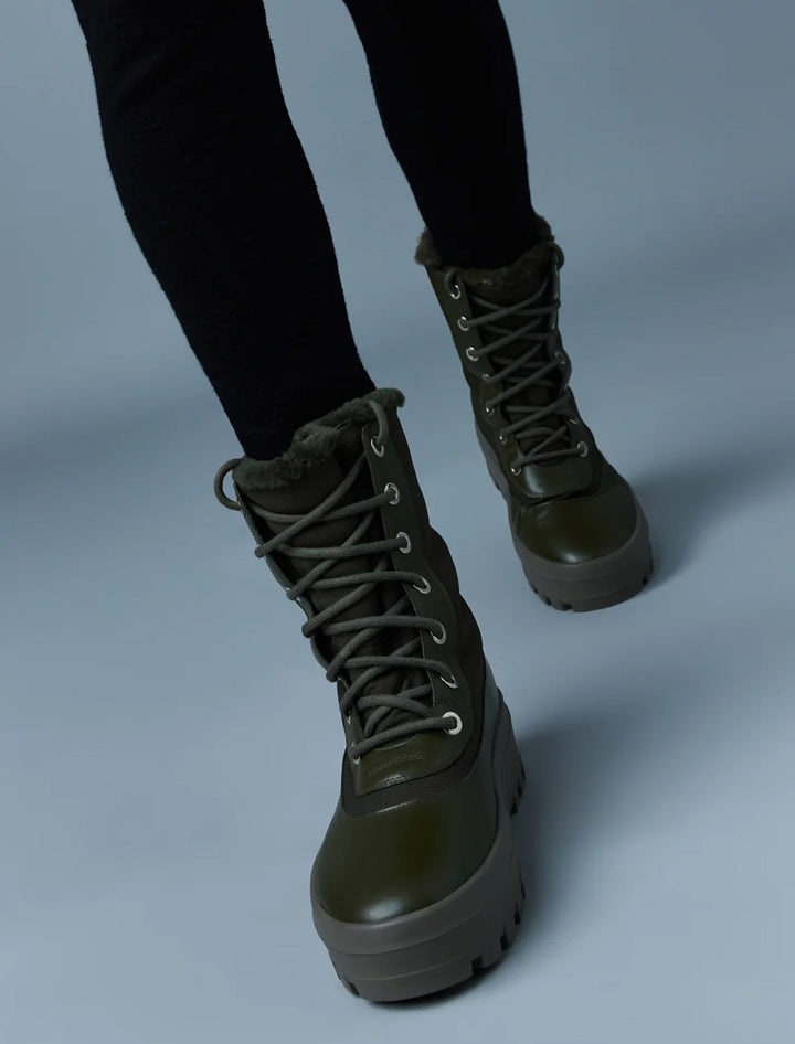 Model wearing Mackage's hero boots in army.