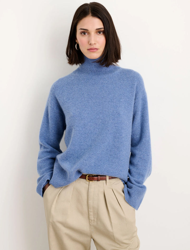 Model wearing cecile turtleneck sweater in cashmere heather blue