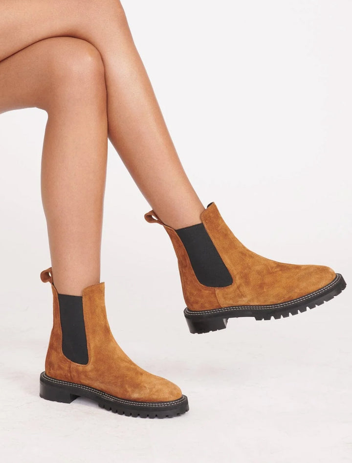 Model wearing Staud's dutch boot in tan.