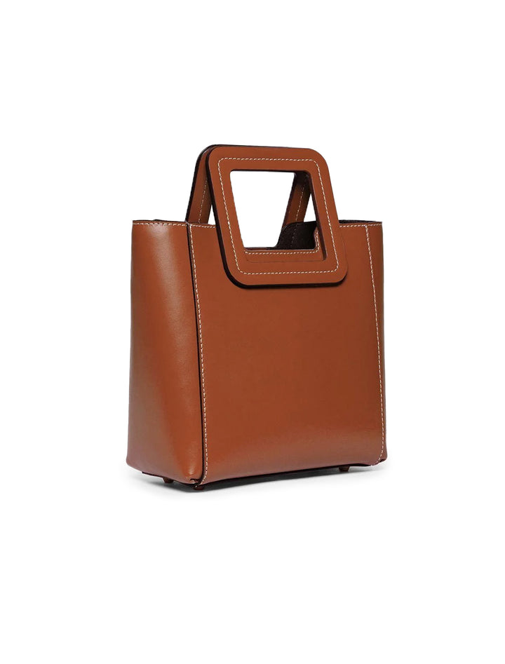 Front angle view of STAUD's mini shirley leather bag in tan.