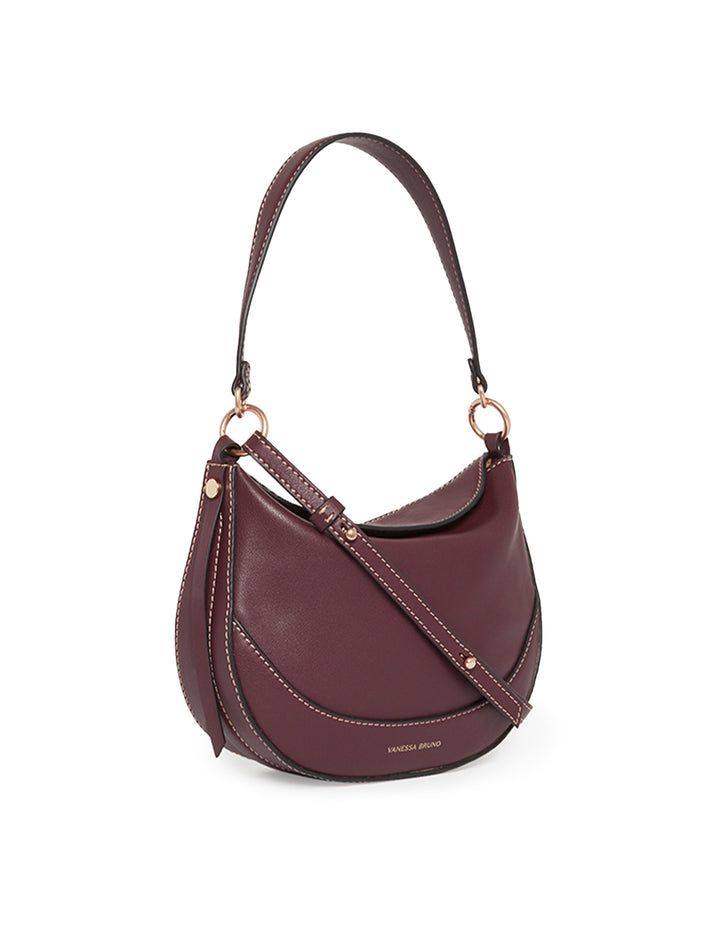 Side angle view of Vanessa Bruno's mini daily bag in bordeaux.