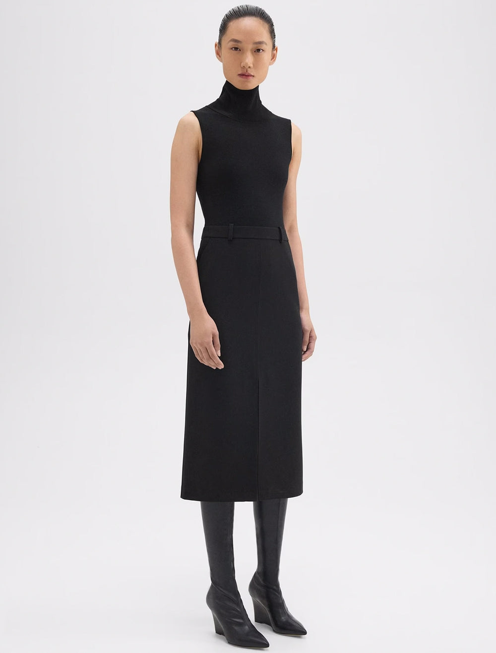 Model wearing Theory's funnel neck dress in black.