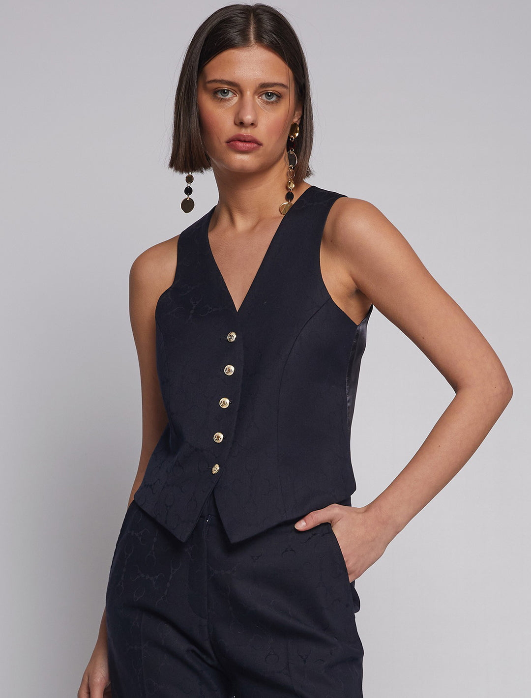 Model wearing Vilagallo's chaleco horsebit jacquard vest.