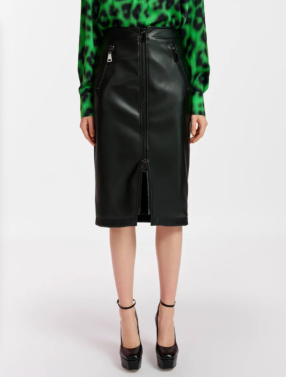 Model wearing Essentiel Antwerp's encourage faux leather skirt in black.