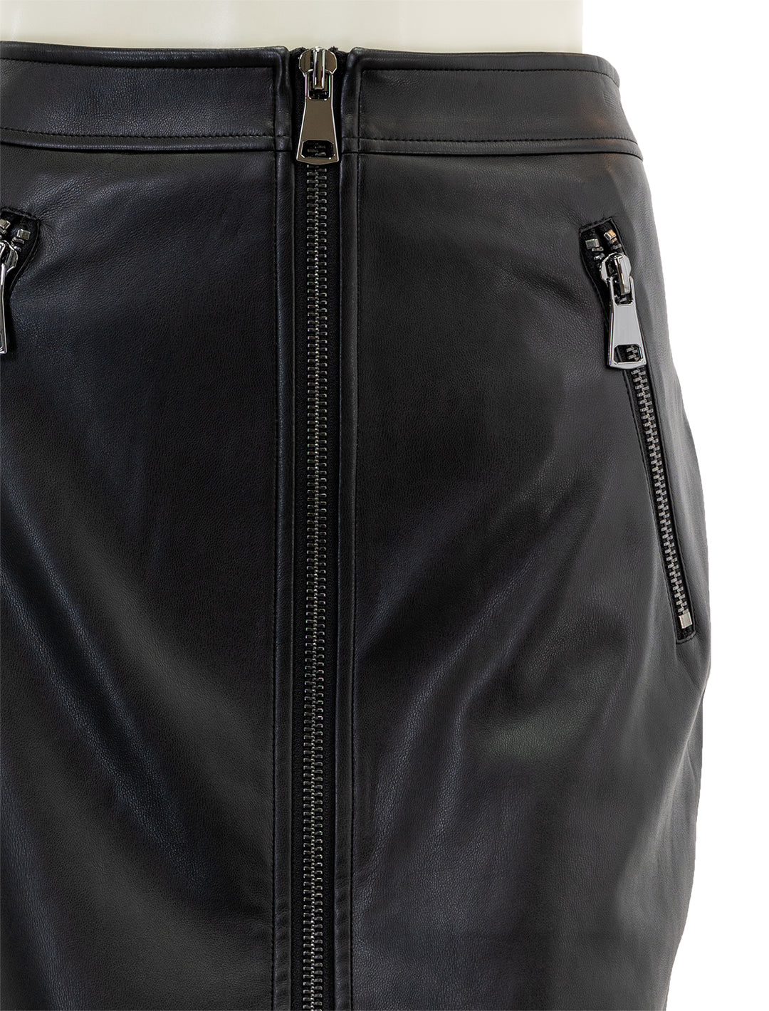 Close-up view of Essentiel Antwerp's encourage faux leather skirt in black.