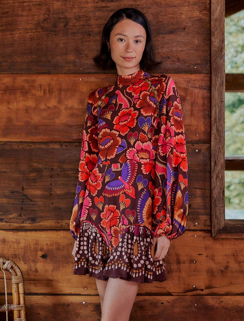 Model wearing Farm Rio's bright flora brown long sleeve mini dress.