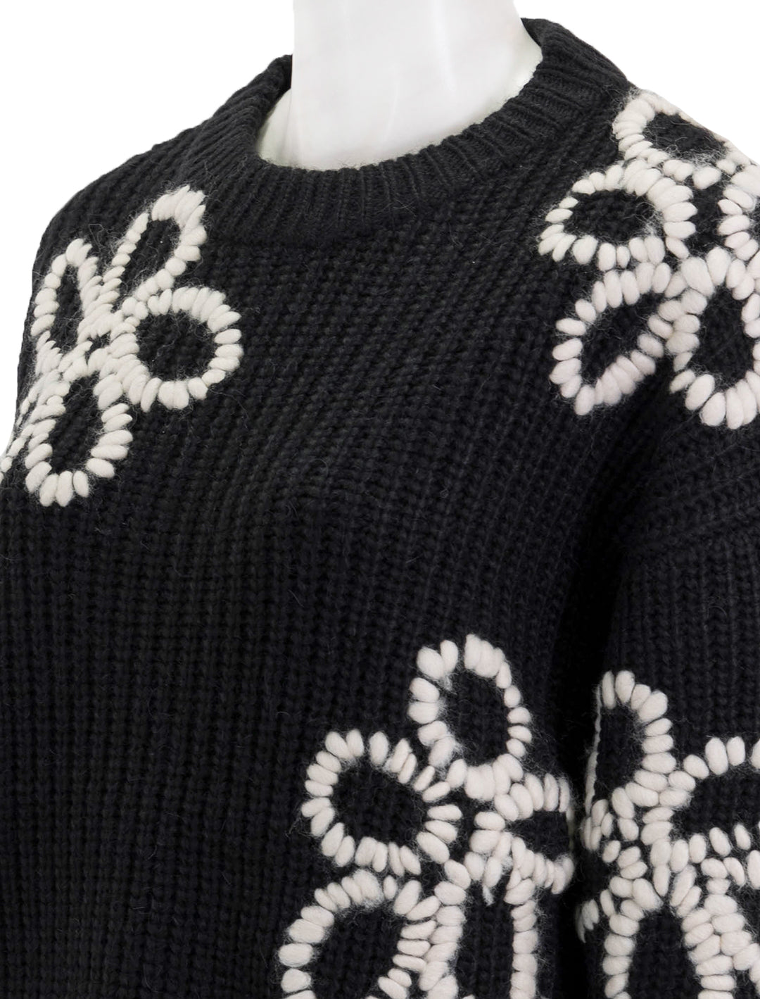 Close-up view of Essentiel Antwerp's eschew embroidered pullover in black