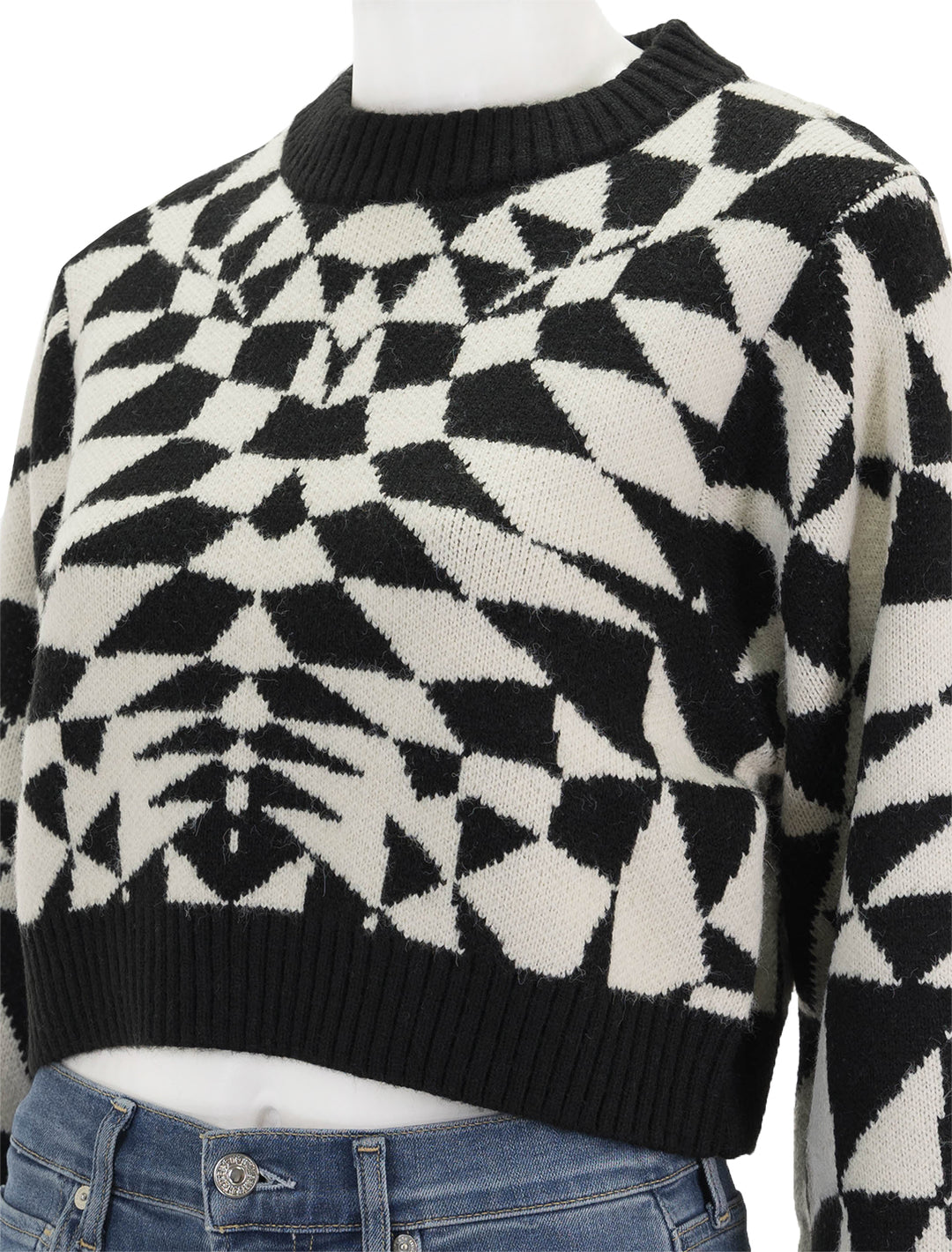 Close-up view of FARM Rio's heart deco black knit sweater.