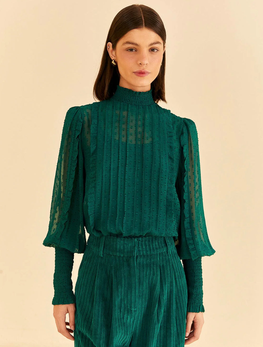 Model wearing FARM Rio's emerald ruffled blouse.
