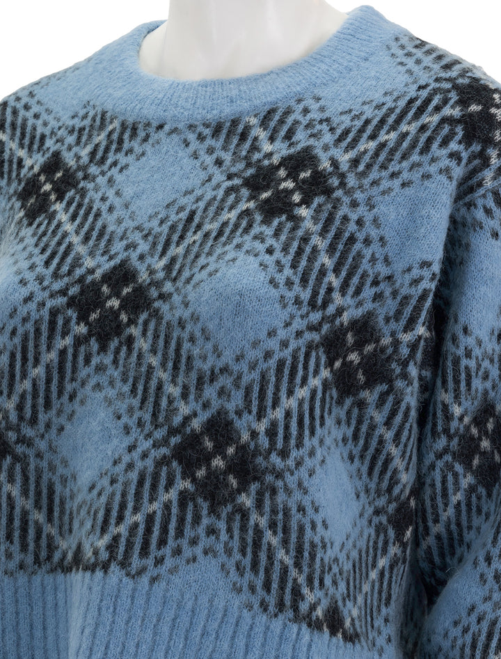 Close-up view of GANNI's check wool oversized pullover in silver lake blue.