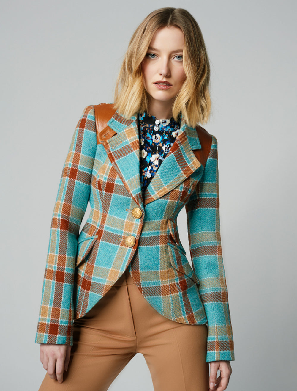 Model wearing Smythe's hunting blazer in blue and rust plaid.