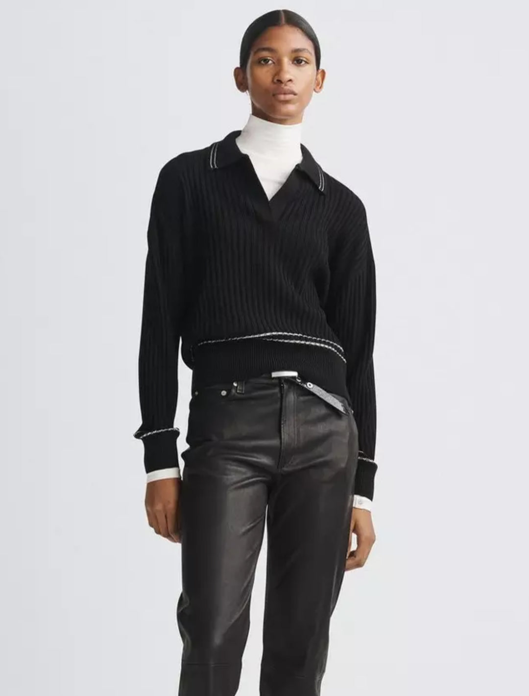 Model wearing Rag & Bone's monti polo in black.