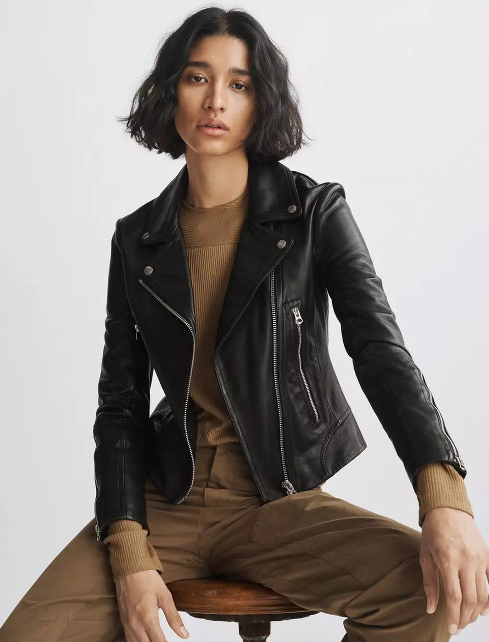 Model wearing Rag & Bone's mack jacket in black.