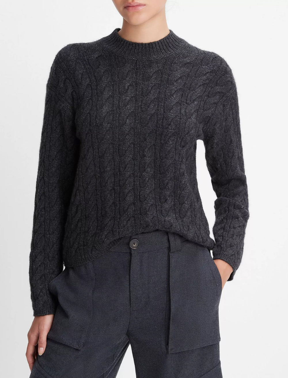 Model wearing Vince's twist cable cropped crew sweater in charcoal.