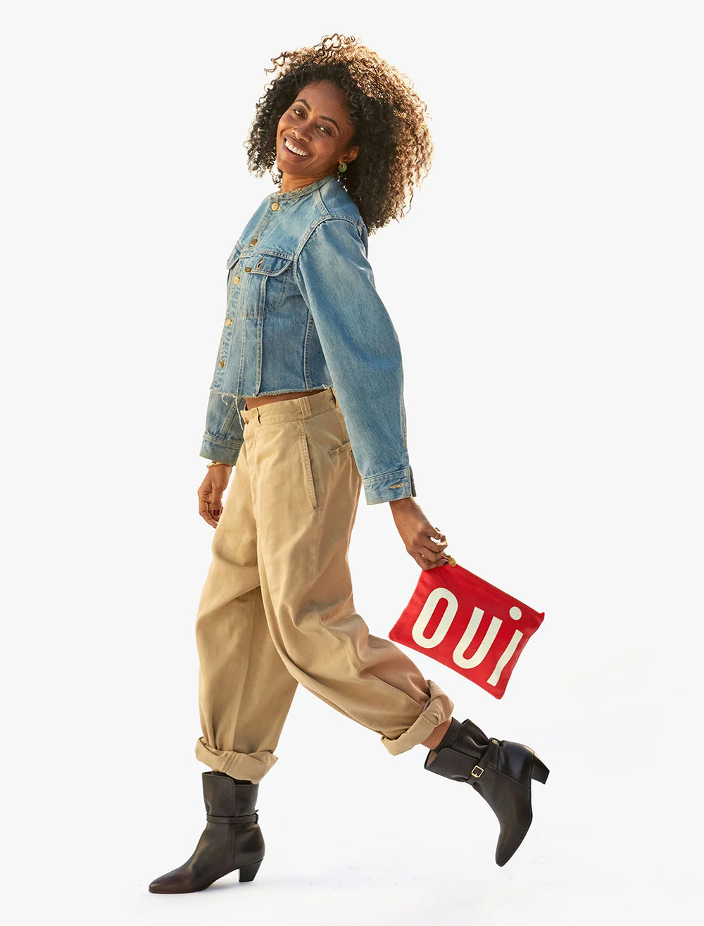 model holding oui flat clutch with tabs in cherry red