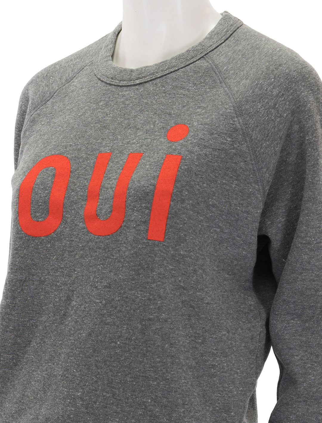 Close-up view of Clare V.'s oui sweatshirt in heather grey and poppy.