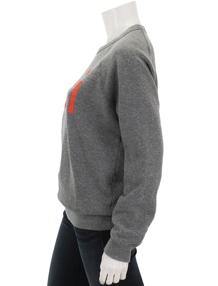 Side view of Clare V.'s oui sweatshirt in heather grey and poppy.