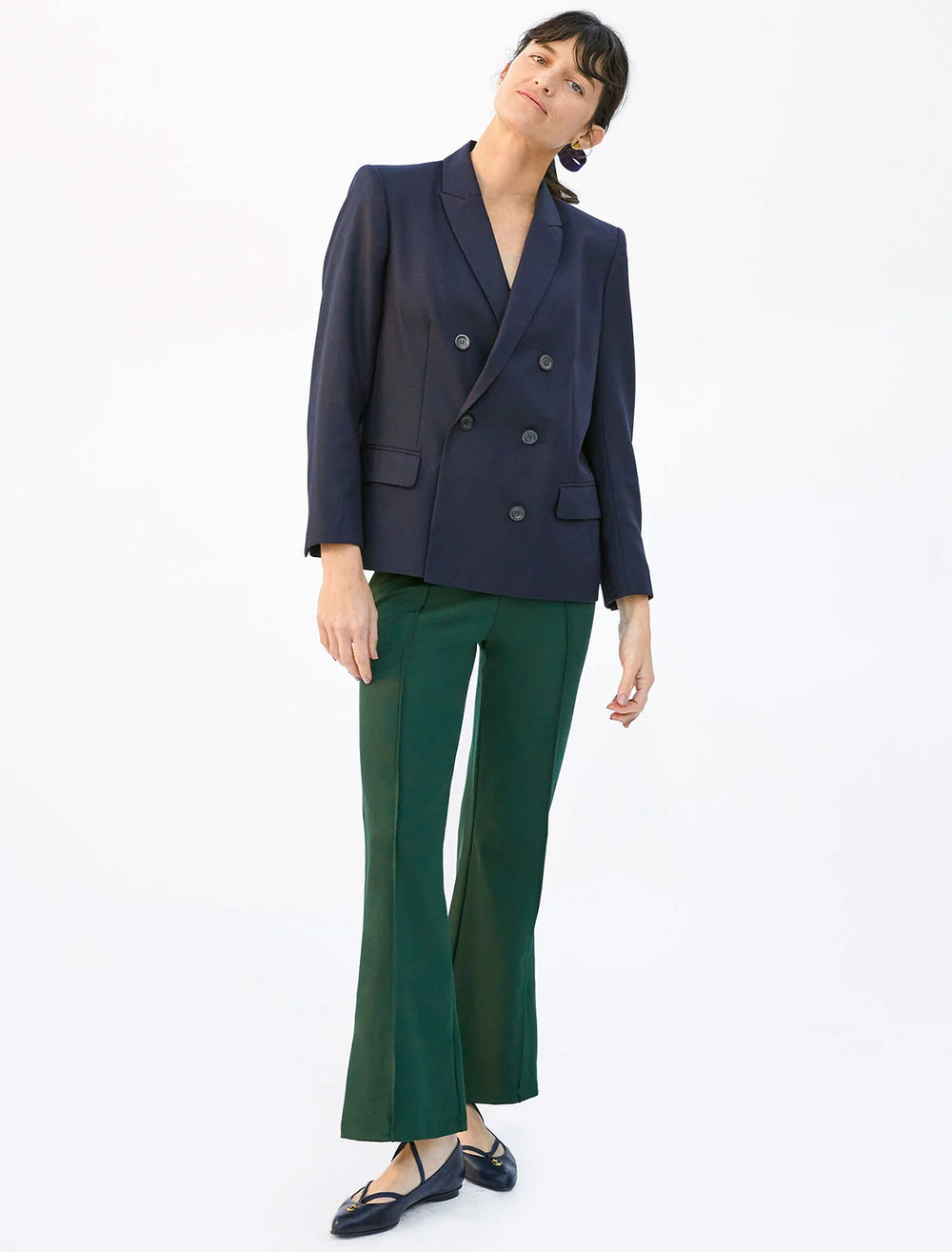 Model wearing Clare V.'s le flare ponte pant in forest.