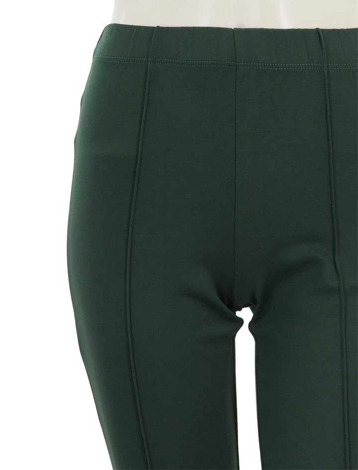 Close-up view of Clare V.'s le flare ponte pant in forest.