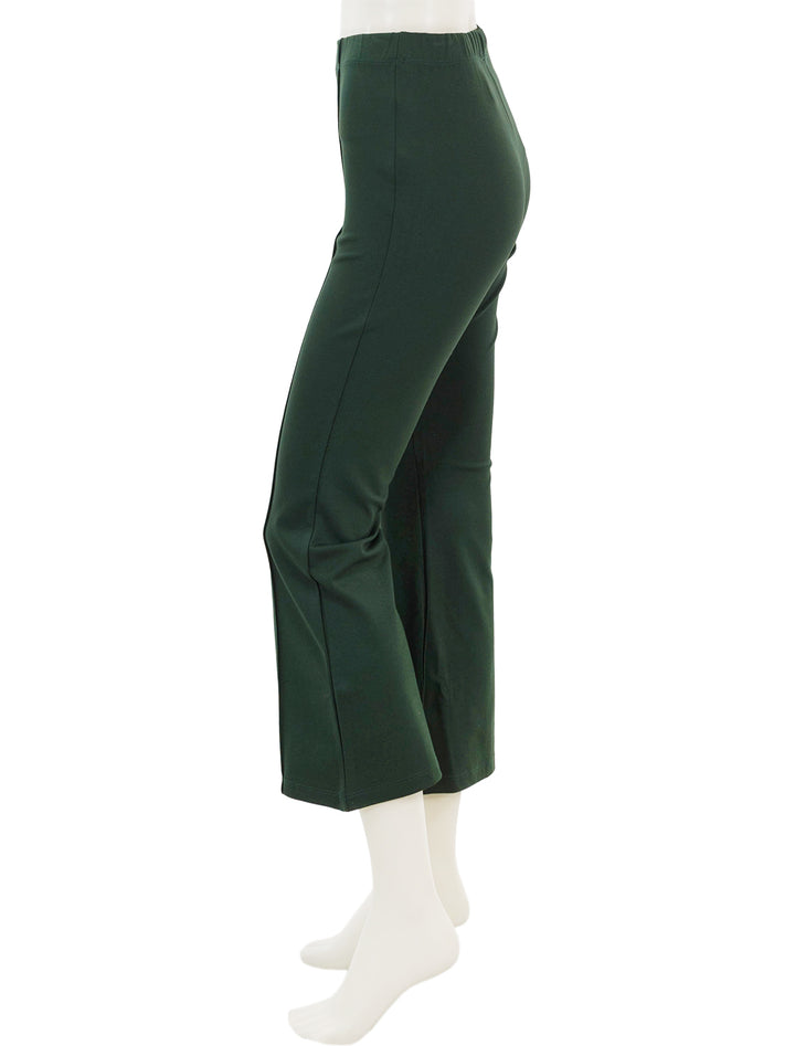 Side view of Clare V.'s le flare ponte pant in forest.