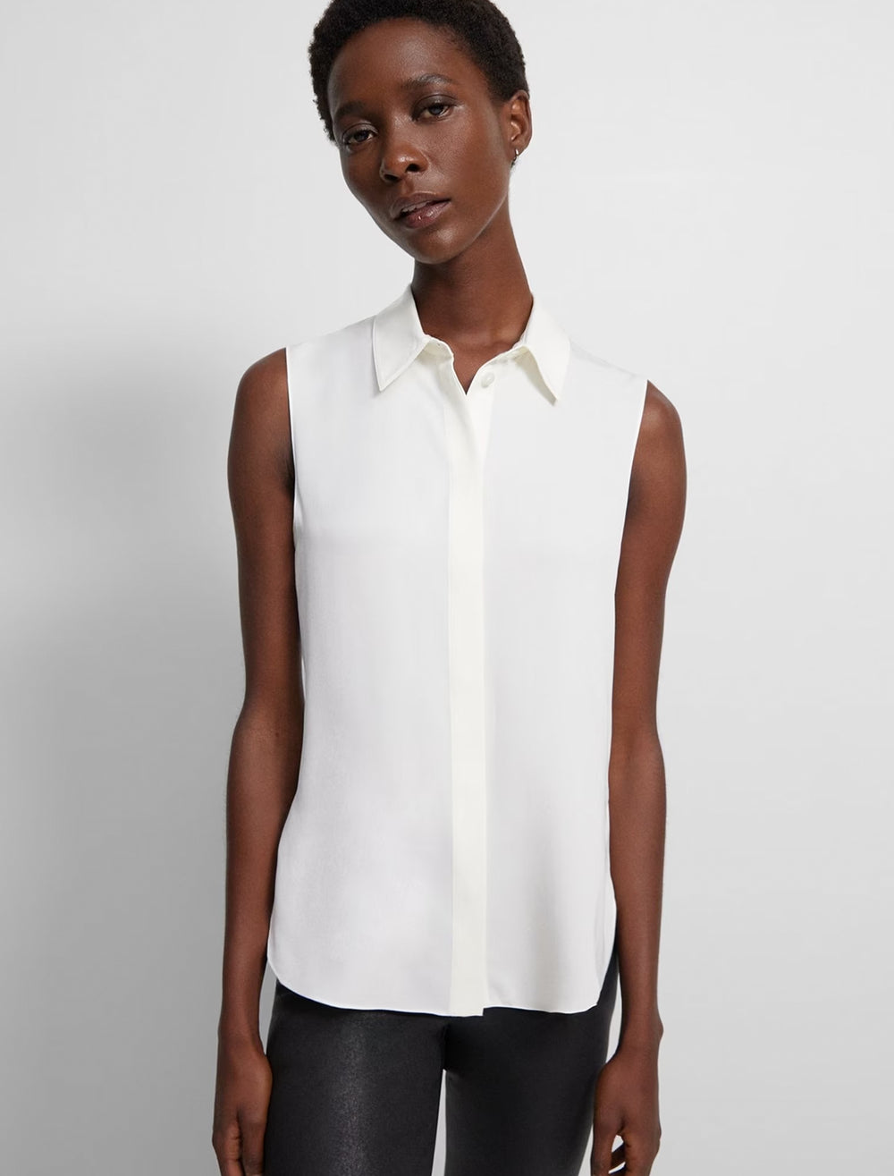 Model wearing Theory's tanelis modern sleeveless blouse in ivory.