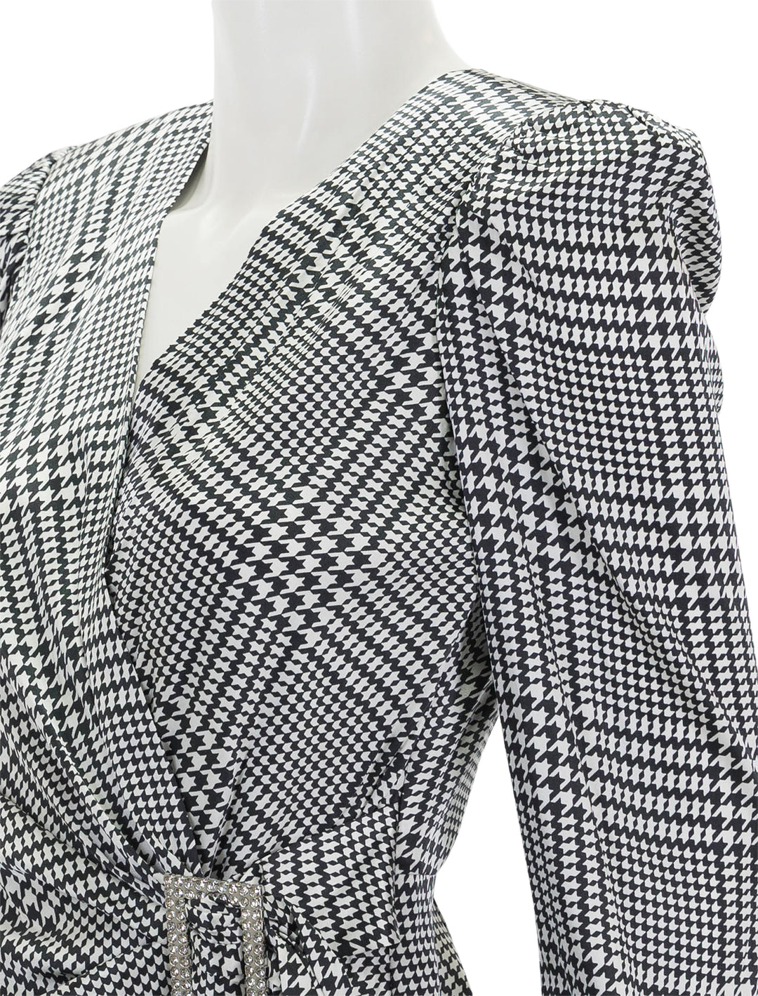 Close-up view of L'agence's bensen wrap blouse in ivory and black plaid.