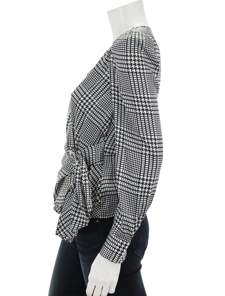 Side view of L'agence's bensen wrap blouse in ivory and black plaid.