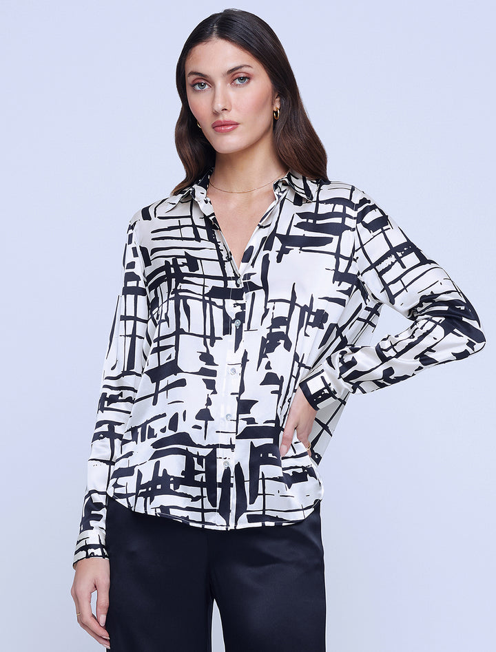 Model wearing L'agence's tyler long sleeve blouse in ivory and black sketch.