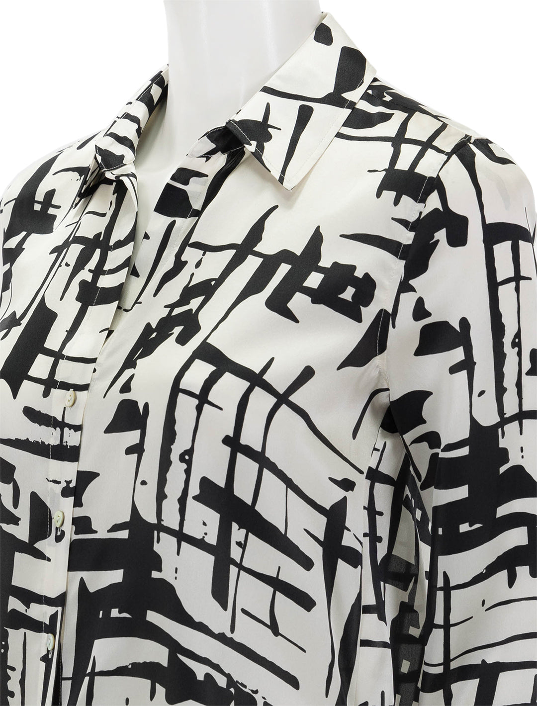 Close-up view of L'agence's tyler long sleeve blouse in ivory and black sketch.
