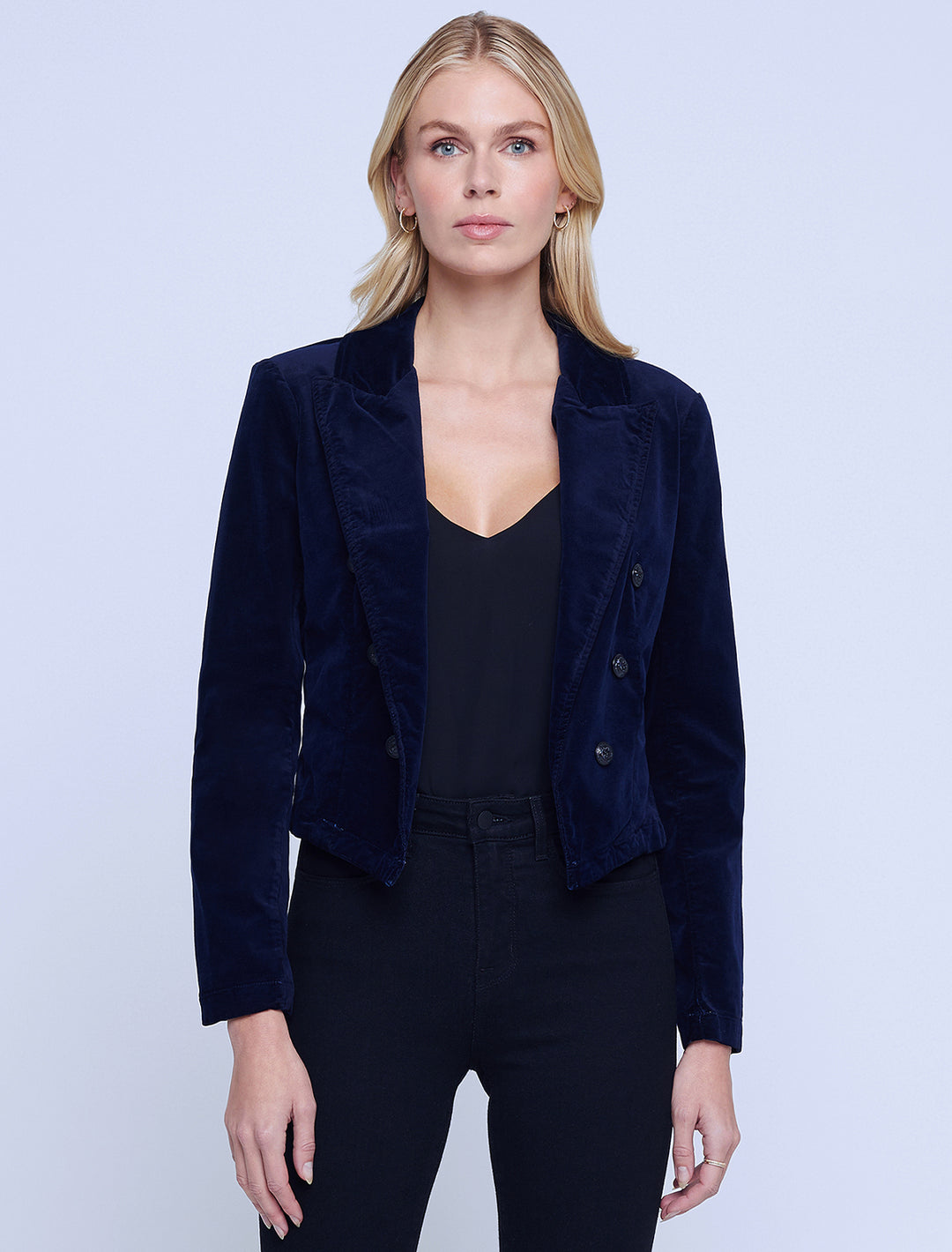 Model wearing L'agence's wayne crop double breasted jacket in dark navy velvet.