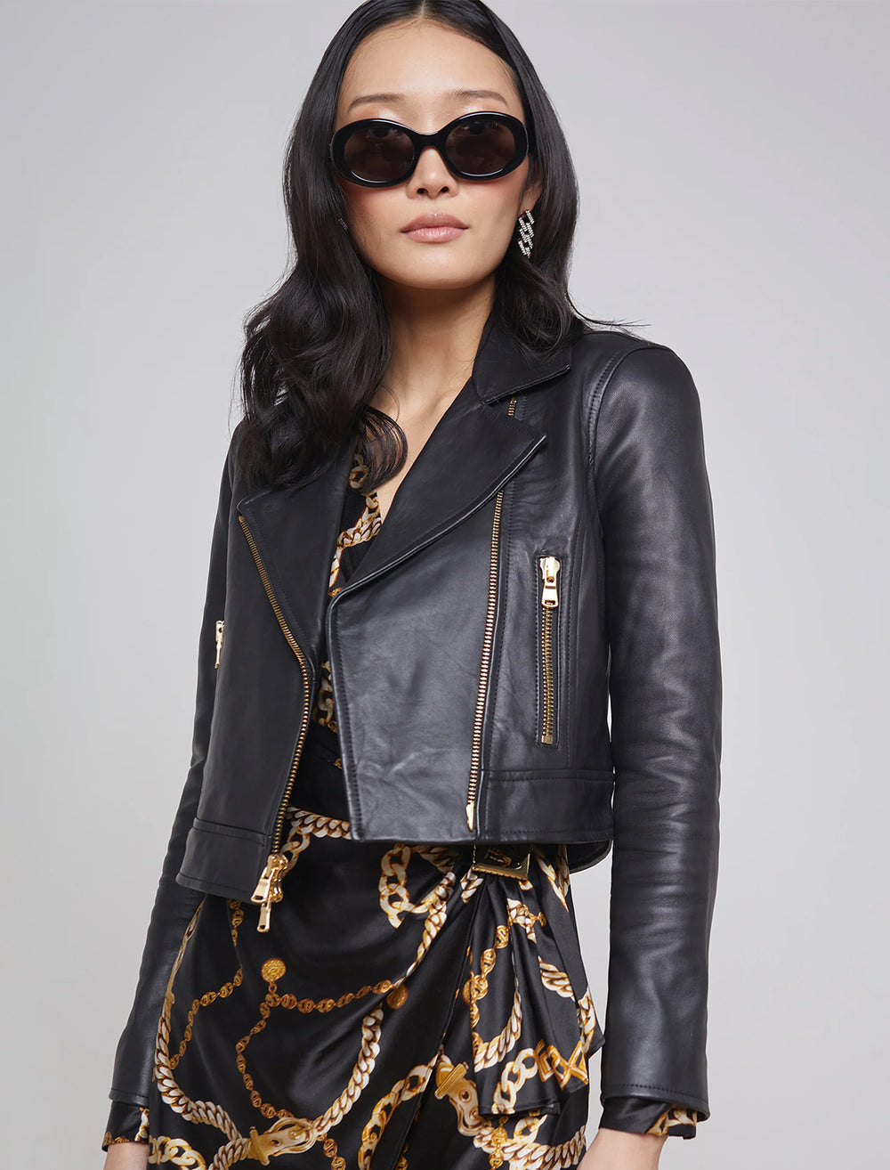 Model wearing L'agence's onna cropped biker jacket in black.