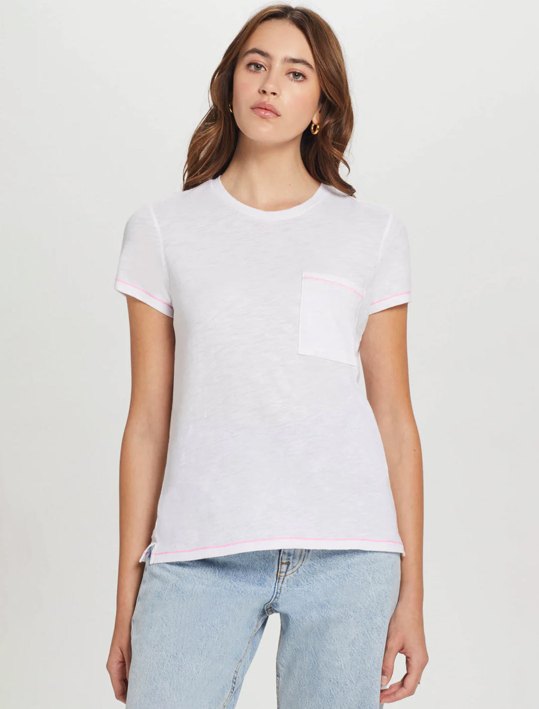Model wearing Goldie Lewinter's contrast stitch pocket boy tee in white and pink.