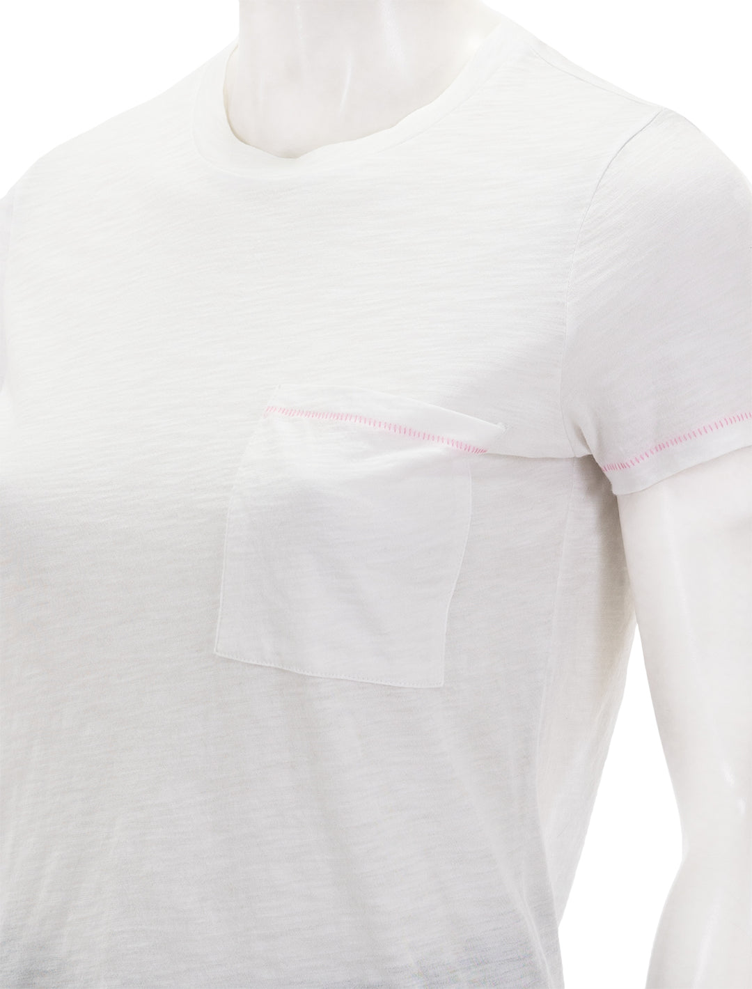Close-up view of Goldie Lewinter's contrast stitch pocket boy tee in white and pink.