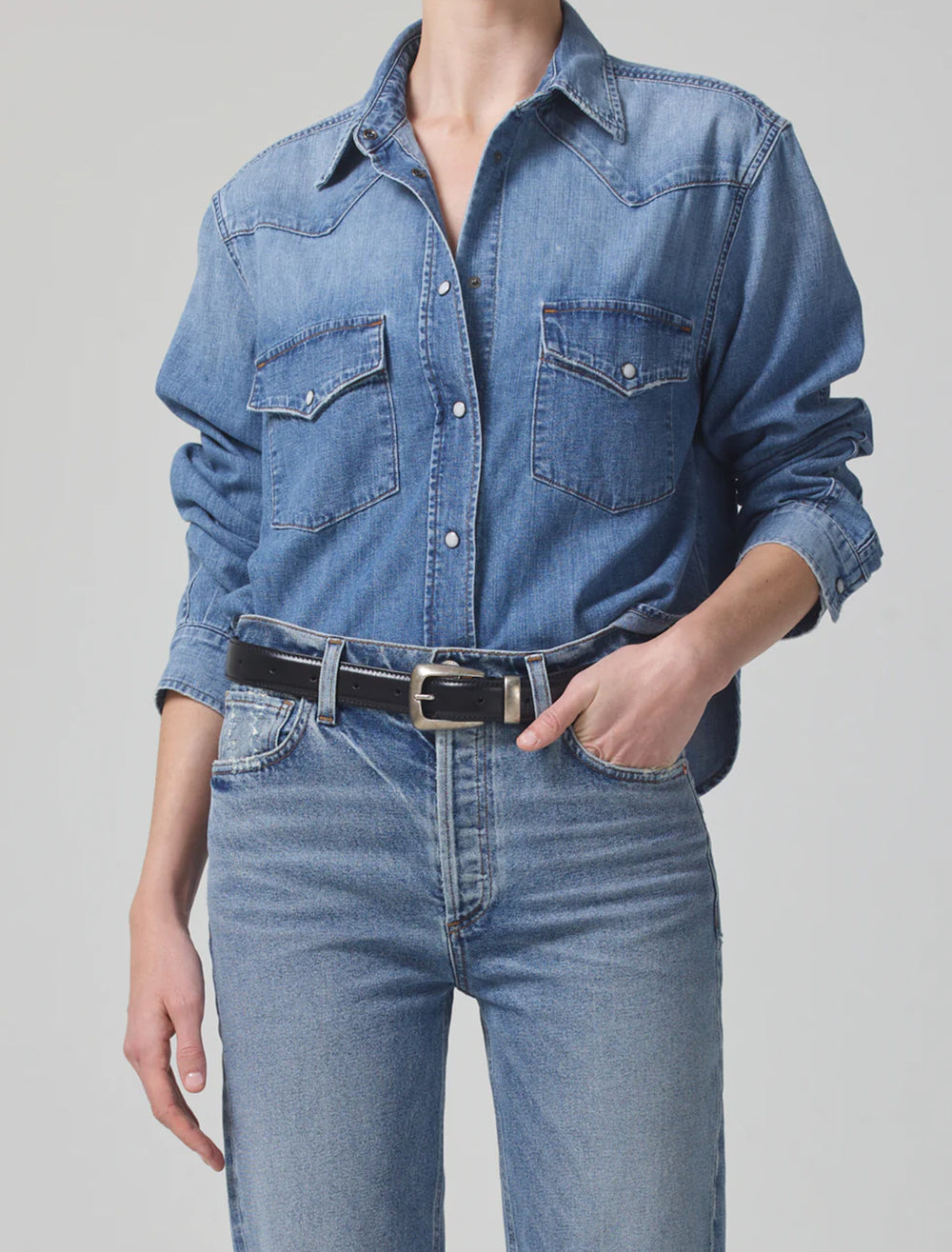 Model wearing Citizens of Humanity's cropped western shirt in carolina blue.